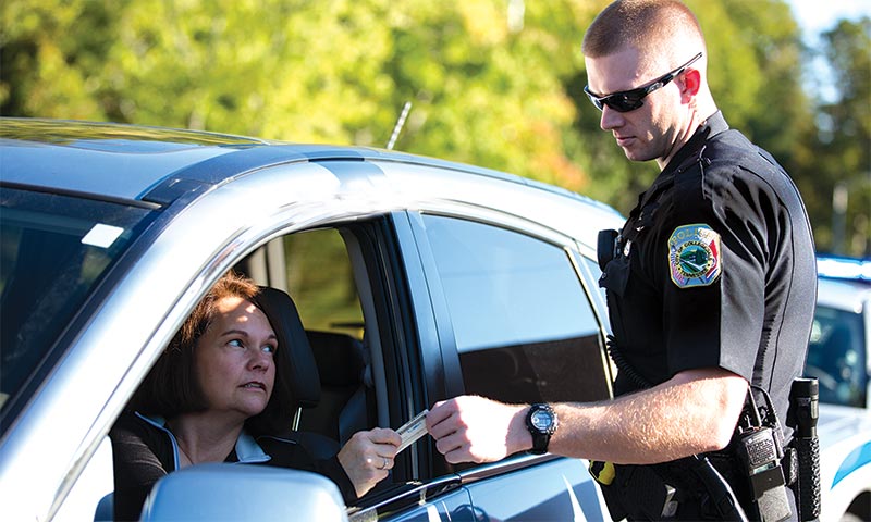 Officer checking the license of a driver
