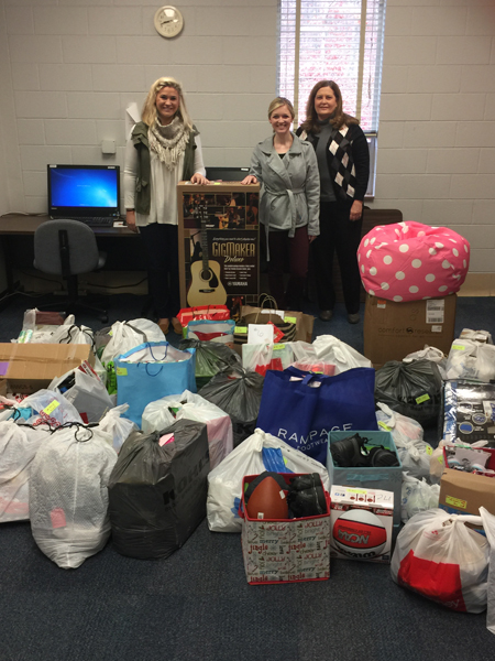 Pictured from left to right: Nikki Davis and Kristin Bowers, H.O.P.E. Center Family Advocates; and  Sherry Holloway, CSCC Service-Learning Director, stand with all of the gifts donated to the H.O.P.E. Center by CSCC faculty, staff and students.